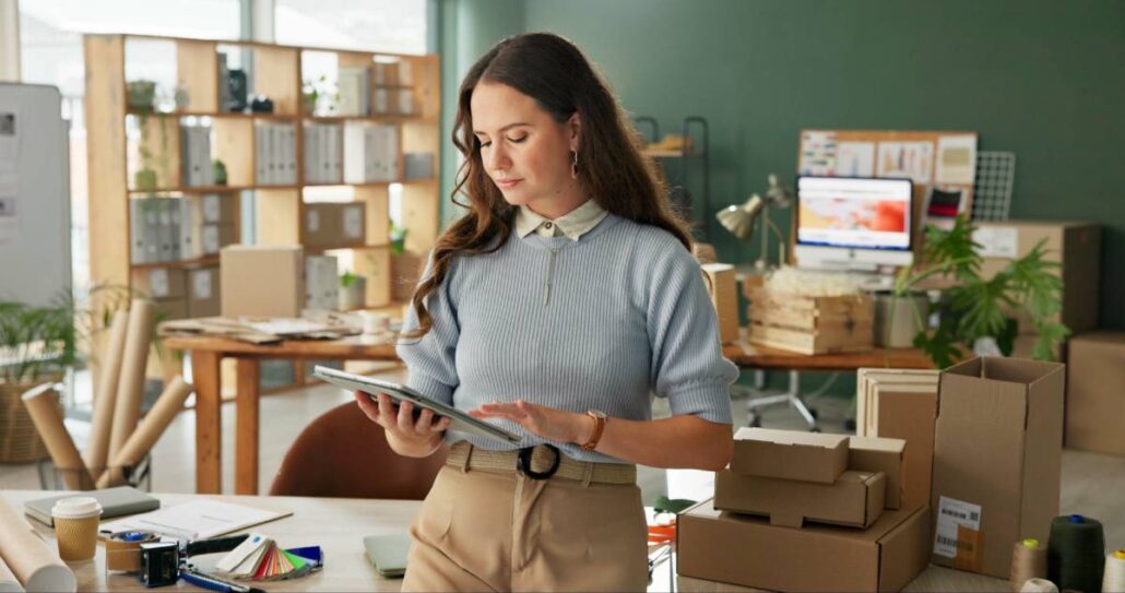A woman on a tablet looking at inventory management.