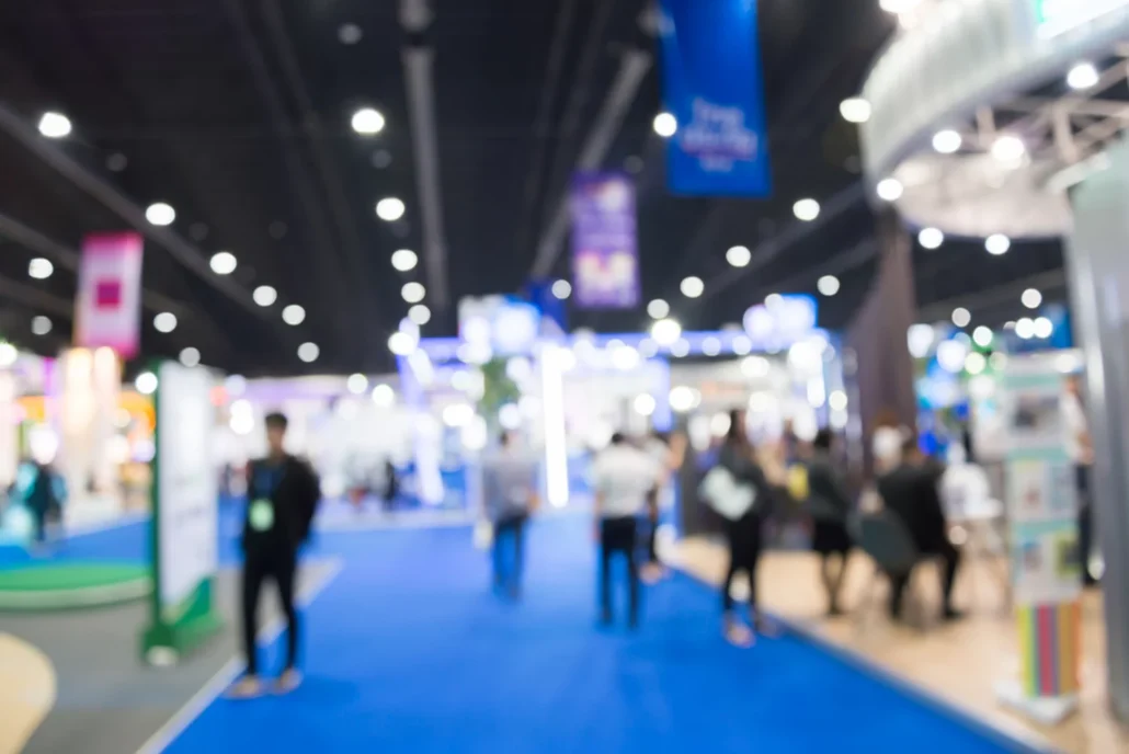 A blurred view of booths at a tradeshow.