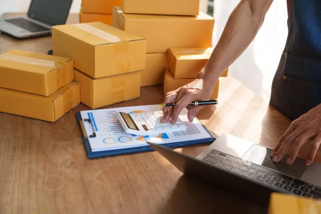 A man shipping a tableful of packages.