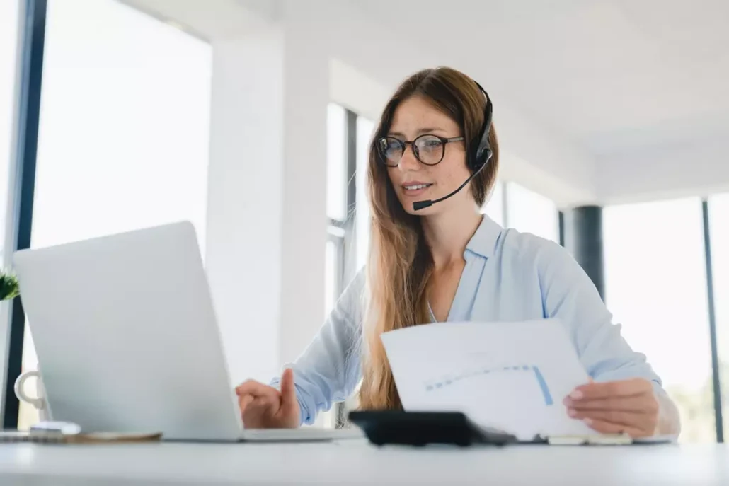 A young woman in HR, smiling as she realizes the systems in place that make their online company store easier to use.